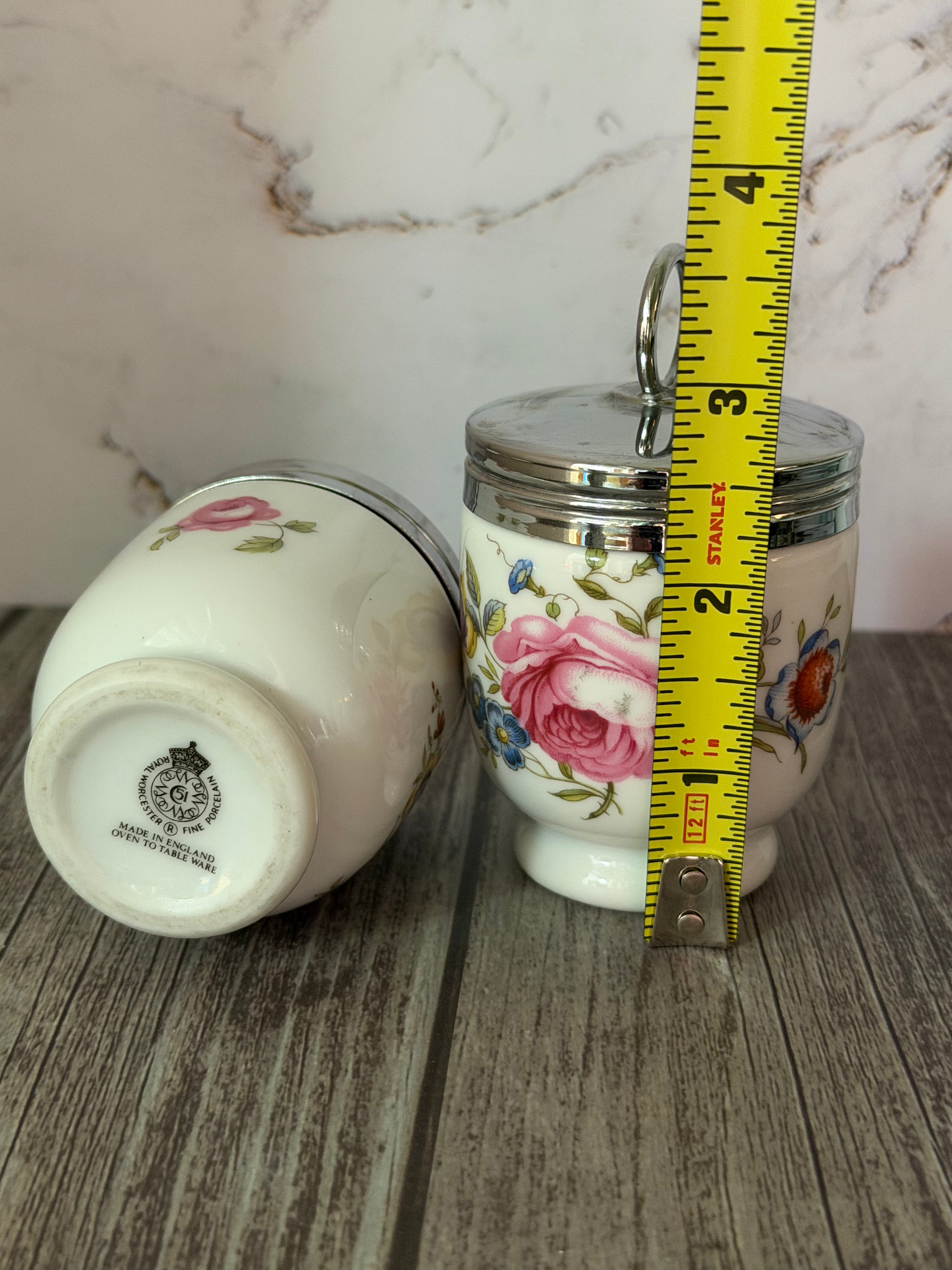 Small ceramic jar with floral design on a wooden surface, next to a measuring tape for scale.